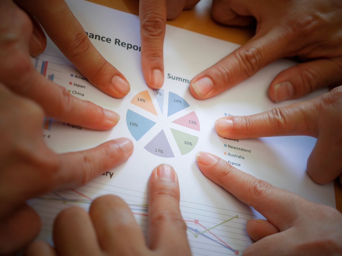 Group of business teamwork point finger to the business report. Concept of business succession.